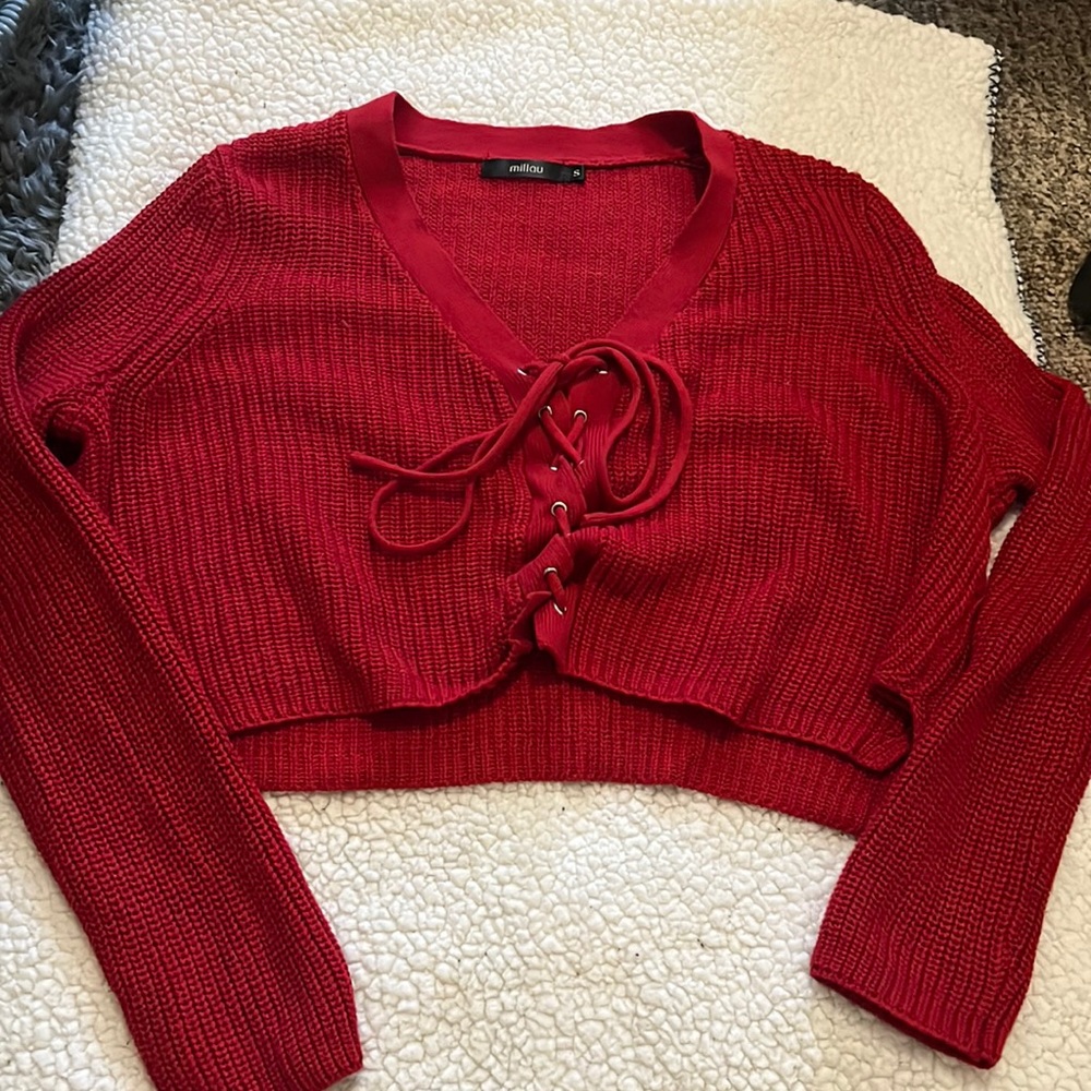 This is a red sweater from Millou. The size is small.